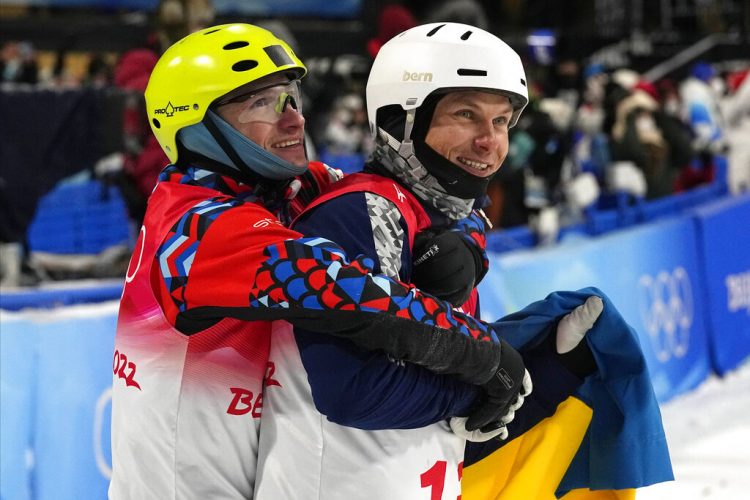 Ukrainian and Russian celebrate with hug at Beijing Olympics